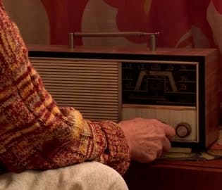 senior-woman-tuning-vintage-radio-footage-104891920_iconl copy
